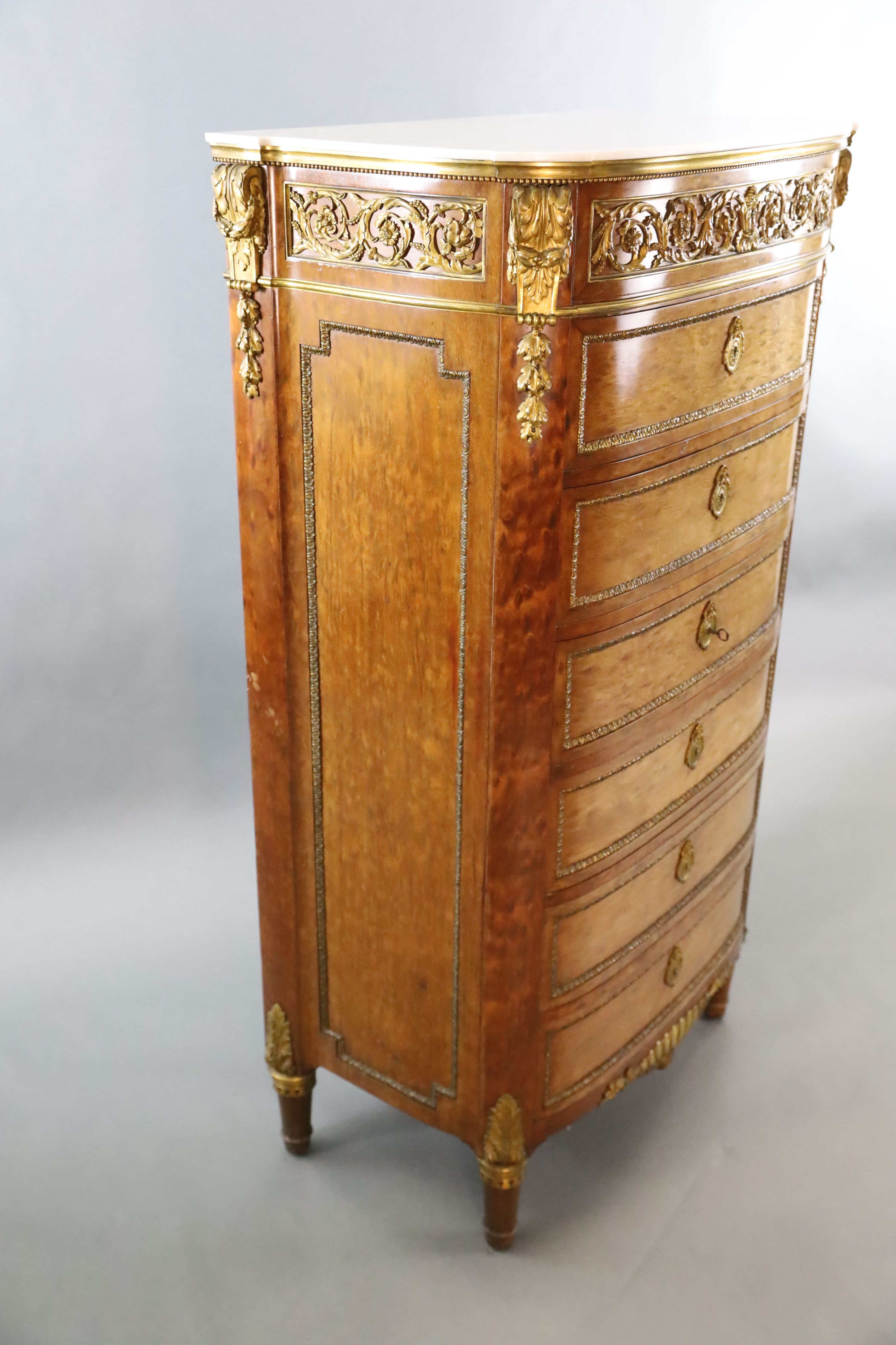 A Louis XVI style ormolu mounted mahogany semanier, W.2ft 7.5in. D.1ft 6.5in. H.4ft 7.5in.